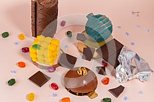 Various sweets assortment. Candy, cakes, bomb on pink background. Top view with copy space