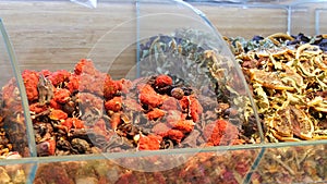 Various tea on the counter of Turkish market. Arabic tea. Dried flower buds and leaves for a future tea party