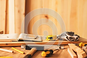 Various tools on carpentry woodwork workshop desk, selective focus