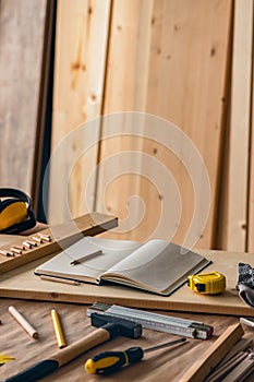 Various tools on carpentry woodwork workshop desk, selective focus