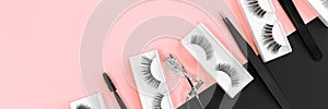 Various tools for eye lash extensions on trendy pastel pink and black background. Banner. Concept. Fake eyelashes.