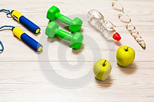 Various tools for fitness on floor in room.