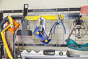 Various tools weigh on vertical mesh rack