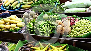 Various tropical fruit in boats selling at floating market.