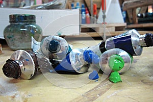 Various tubes of paint driping