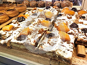 Various types of breads are displayed for sale inside the bakery display rack.