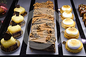 Various types of cakes, tart, mousse, pies for sale in bakery or pastry shop, gourmet luxury concept