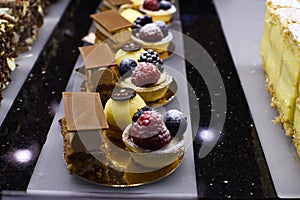 Various types of cakes, tart, mousse, pies for sale in bakery or pastry shop, gourmet luxury concept