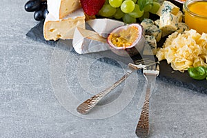 Various types of cheese with berries, honey. Empty space background concept