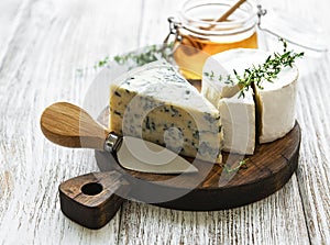 Various types of cheese, blue cheese, bree, camambert and honey