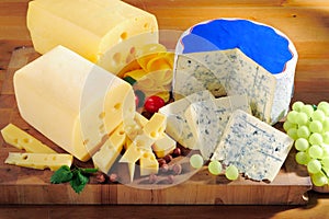 Various types of cheese on cutting board