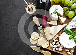 Various types of cheese, grapes and wine