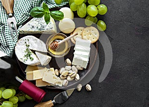 Various types of cheese, grapes and wine