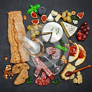 Various types of cheese, meat, fruits and wine