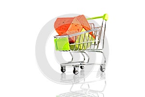 Various types of cheese in metal shopping cart isolated on white background.