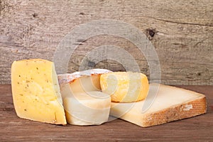 Various types of cheese on a wooden background