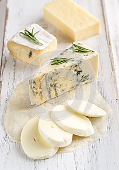 Various types of cheese on the wooden board