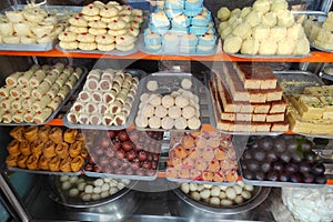 Various types of delicious sweets of Bengal are arranged in a showcase in a sweet shop in Kolkata