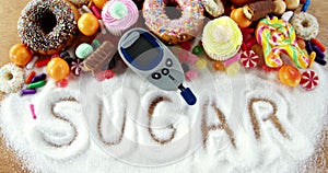 Various types of doughnuts and cupcakes with glucometer