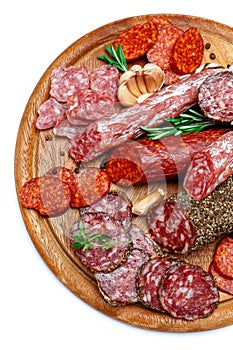 Various types of Dried organic salami sausage on wooden cutting board