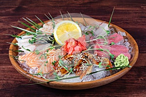 Various types of fish on plate with ice and lemon