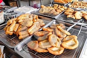 Various types of fried bread sticks or you tiao at hawker stall photo