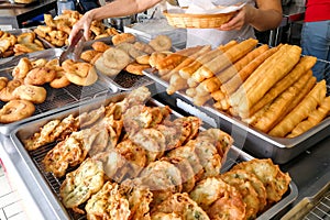 Various types of fried bread sticks or you tiao at hawker stall photo