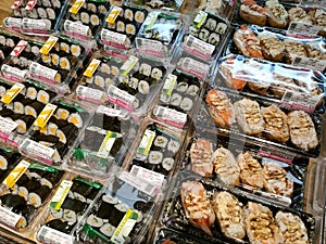 Various types of Japanese sushi ready in packs are on display for sale.