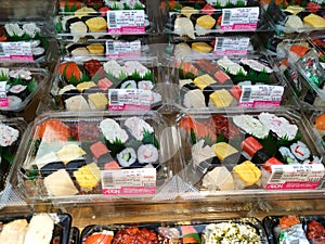 Various types of Japanese sushi ready in packs are on display for sale.