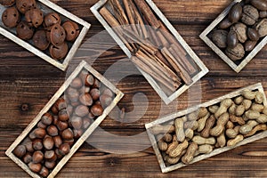 Various types of nuts on a natural wooden background.