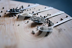 Various types of pepper on a wooden background