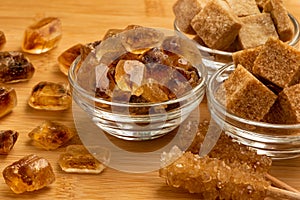 Various types of sugar on the table and in glass bowls