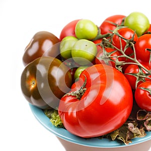 Various types of tomatoes in a bowl on the table