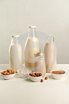 Various vegan plant based milk and ingredients. Dairy free milk substitute drinks in glass bottles