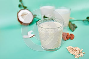 Various vegan plant based milk and ingredients, non-dairy milk, alternative types of vegan milks in glasses