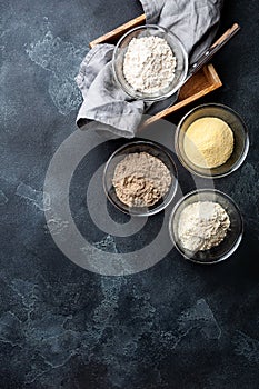 Various vegetable gluten free flour corn,sesame,oat,coconut in glass bowl on dark gray background