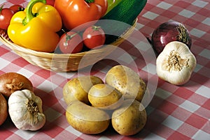 Various vegetables with a basket and retro tablecloth in vintage style