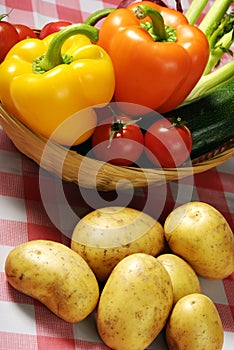 Various vegetables with a basket and retro tablecloth in vintage style