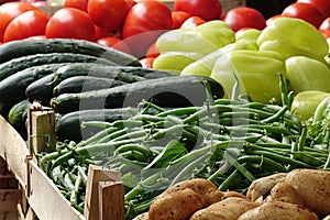 Various vegetables displayed in wooden cases on marketplace