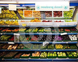 Various vegetables and fruits on display in grocery store