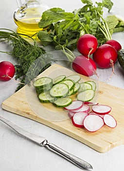 Various vegetables: garden radish, cucumbers, onions on a white