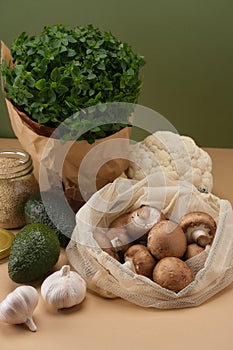 Various vegetables, pasta, mushrooms and cereals in reusable fabric eco bags.