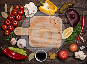 Various vegetables and spices and empty old cutting board. Color