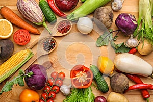 Various vegetables with spices on wooden background