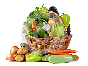 Various vegetables in a wicker basket isolate on white background