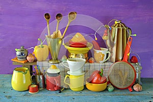 Various vintage kitchen utensils from the seventies with vibrant colors, pop and trashy style kitchen still life photo