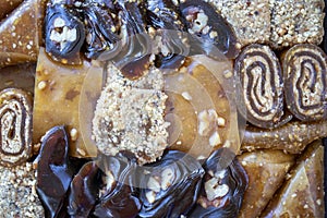 Various walnut, pistachio, hazelnut pestils. Turkish deserts. similar to turkish delight. close-up macro photo.