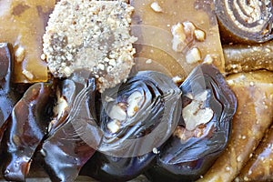 Various walnut, pistachio, hazelnut pestils. Turkish deserts. similar to turkish delight. close-up macro photo.