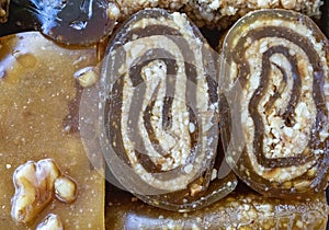 Various walnut, pistachio, hazelnut pestils. Turkish deserts. similar to turkish delight. close-up macro photo.