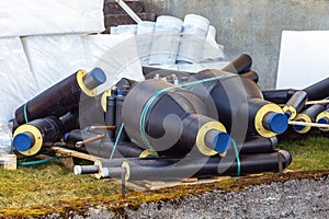 Various water pipes with thermal insulation and connections at the construction site